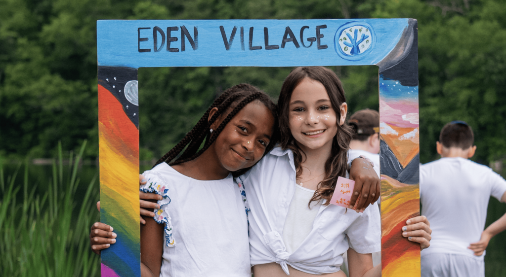 two campers posing in a decorated fram